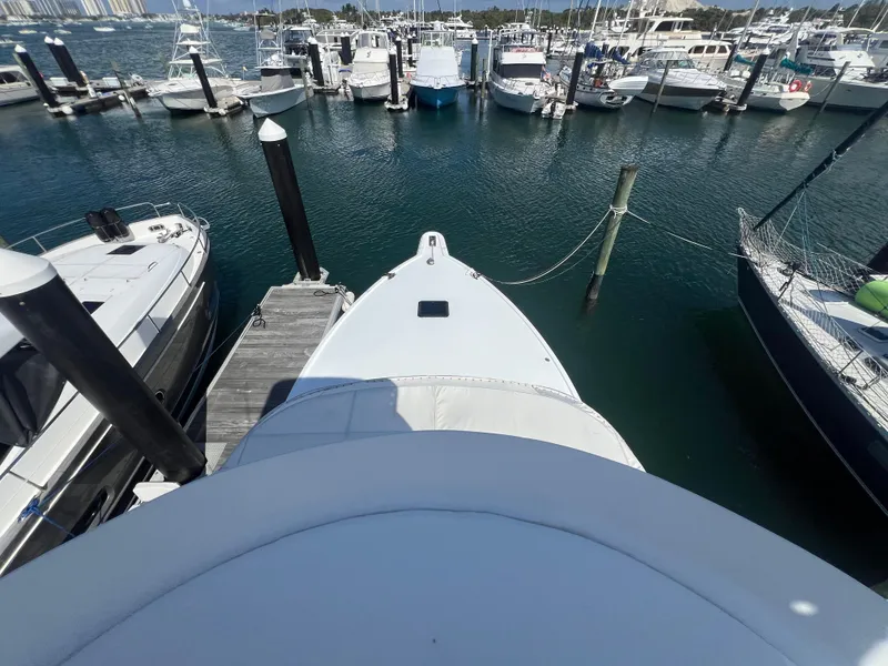 Slide: The Image of Bow view of a 1997 Strike 42 yacht docked at a marina with surrounding boats. - 40
