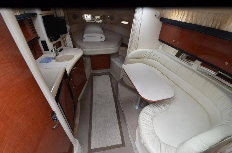 Slide: The Image of Interior of 2002 Sea Ray 340 Sundancer yacht with cozy seating and kitchenette. - 12
