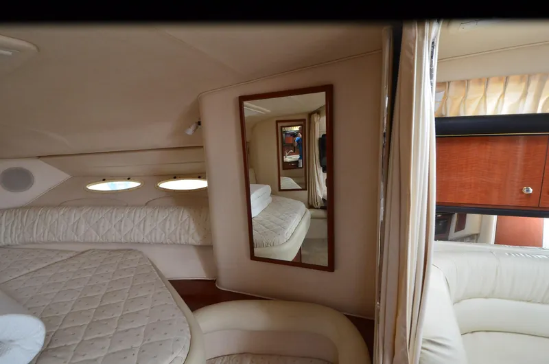 Slide: The Image of Interior of 2002 Sea Ray 340 Sundancer yacht with mirror and seating area. - 19