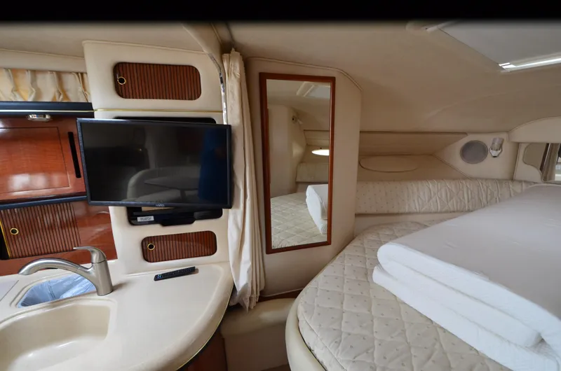 Slide: The Image of Interior of 2002 Sea Ray 340 Sundancer with bed, TV, and sink. - 24