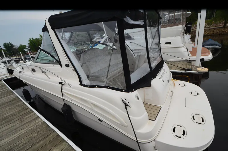 Slide: The Image of 2002 Sea Ray 340 Sundancer docked, featuring a covered cockpit and sleek design. - 3