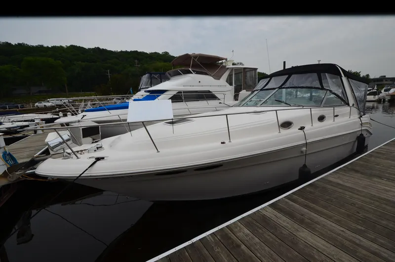 Slide: The Image of 2002 Sea Ray 340 Sundancer docked at marina, side view. - 4