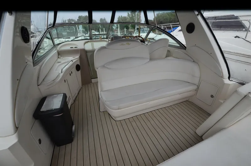 Slide: The Image of 2002 Sea Ray 340 Sundancer interior with white seating and wood flooring. - 6