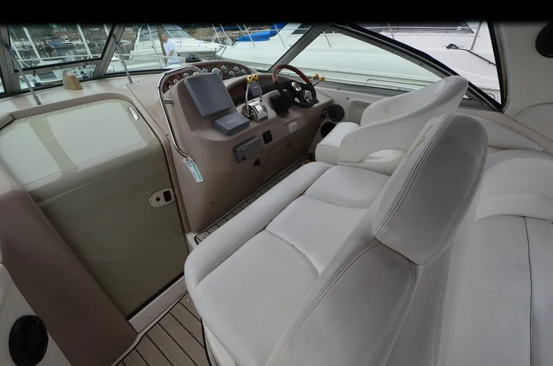 Slide: The Image of 2002 Sea Ray 340 Sundancer cockpit with plush seating and modern controls. - 7