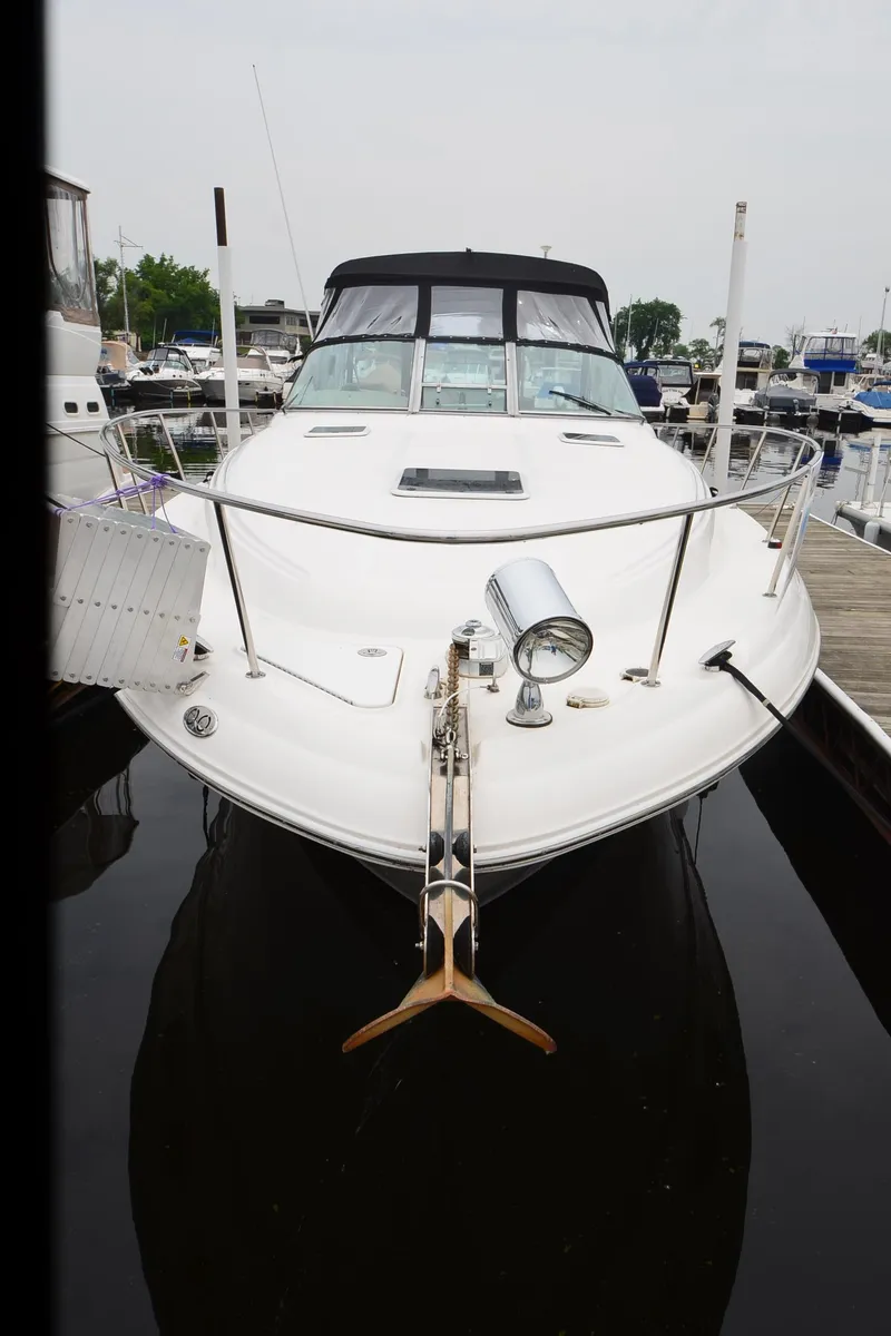 Slide: The Image of 2002 Sea Ray 340 Sundancer docked at marina, front view. - 9