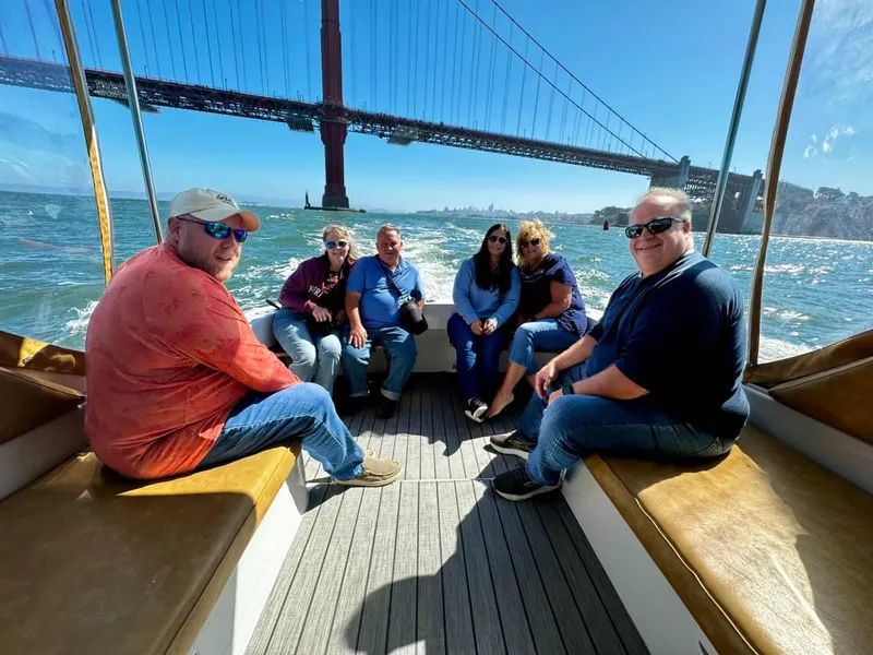 Slide: The Image of Group enjoying a boat ride on a 1999 Mainship Pilot 30 near the Golden Gate Bridge. - 16