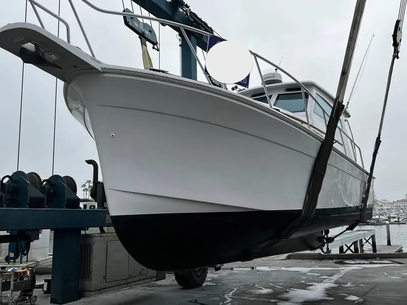 Slide: The Image of 1999 Mainship Pilot 30 boat on lift at marina, side view. - 21