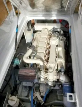 Slide: The Image of Engine compartment of a 1999 Mainship Pilot 30 boat, showcasing detailed mechanical components. - 9