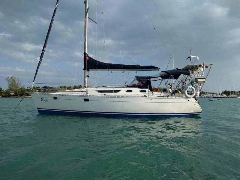 Slide: The Image of 1997 Jeanneau Sun Odyssey 36.2 sailboat on calm water under cloudy sky. - 1