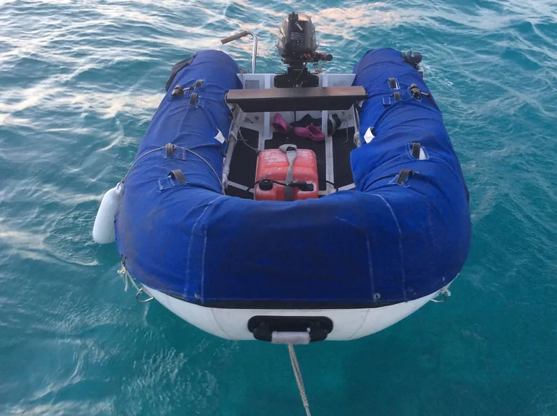Slide: The Image of Inflatable dinghy with motor on turquoise water, associated with Jeanneau Sun Odyssey 36.2, 1997. - 11