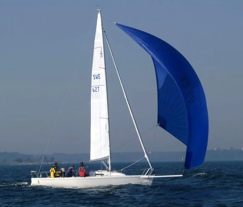 Slide: The Image of Sailing yacht Jeanneau Sun Odyssey 36.2, 1997 model, with blue spinnaker on open water. - 2