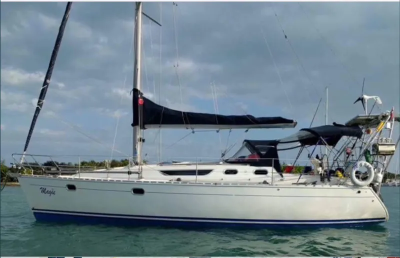 Slide: The Image of 1997 Jeanneau Sun Odyssey 36.2 sailboat on calm water under cloudy sky. - 4