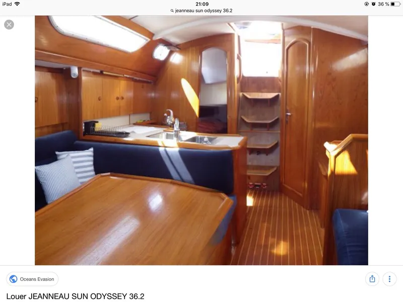 Slide: The Image of Interior of 1997 Jeanneau Sun Odyssey 36.2 sailboat with wooden finish and cozy seating. - 7