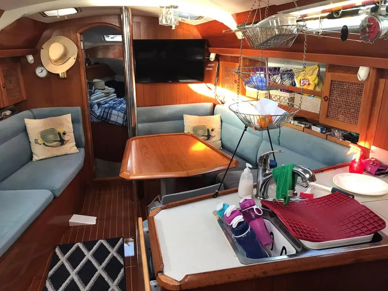 Slide: The Image of Interior of 1997 Jeanneau Sun Odyssey 36.2 sailboat with cozy seating and kitchen area. - 9