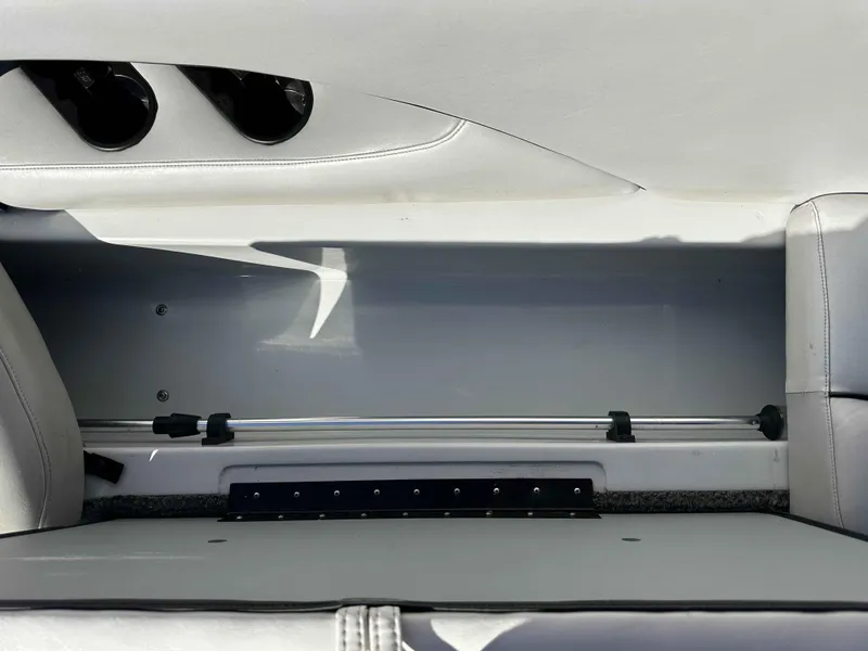 Slide: The Image of 2007 Sanger V215 boat interior storage compartment with cup holders and sleek design. - 14