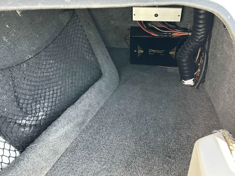Slide: The Image of 2007 Sanger V215 interior storage compartment with wiring and netting. - 17
