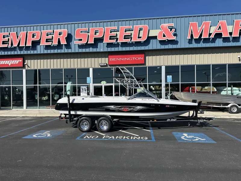 Slide: The Image of 2007 Sanger V215 boat on trailer outside dealership, parked in handicap spot. - 2