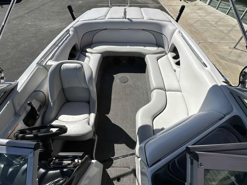 Slide: The Image of 2007 Sanger V215 boat interior with white seating and steering wheel. - 24