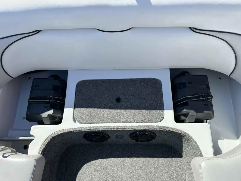 Slide: The Image of 2007 Sanger V215 boat interior with storage compartments and speakers. - 25