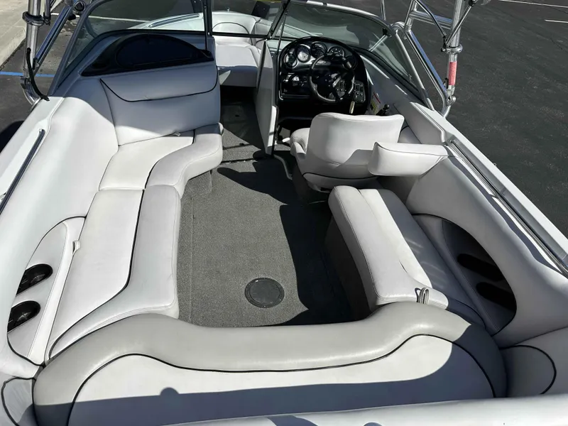 Slide: The Image of 2007 Sanger V215 boat interior with white seating and steering console. - 26