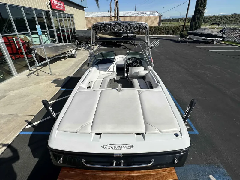 Slide: The Image of 2007 Sanger V215 boat parked outside a dealership, showcasing sleek design and spacious interior. - 6