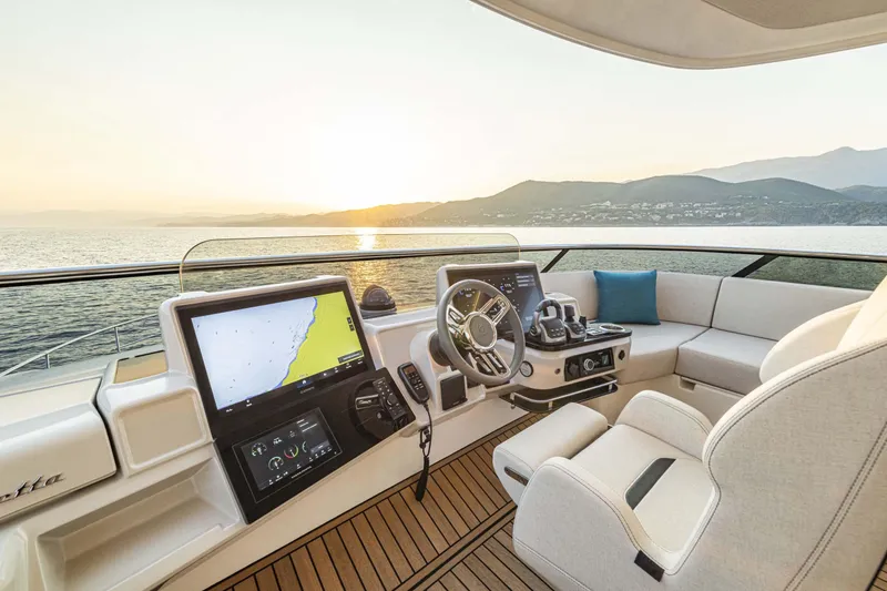 Slide: The Image of Luxury helm of 2026 Absolute 70' Navetta yacht at sunset, featuring advanced navigation systems. - 16