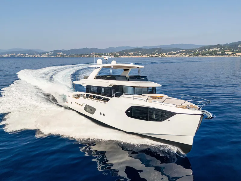 Slide: The Image of Luxury Absolute 70' Navetta yacht cruising on open water, 2026 model. - 1