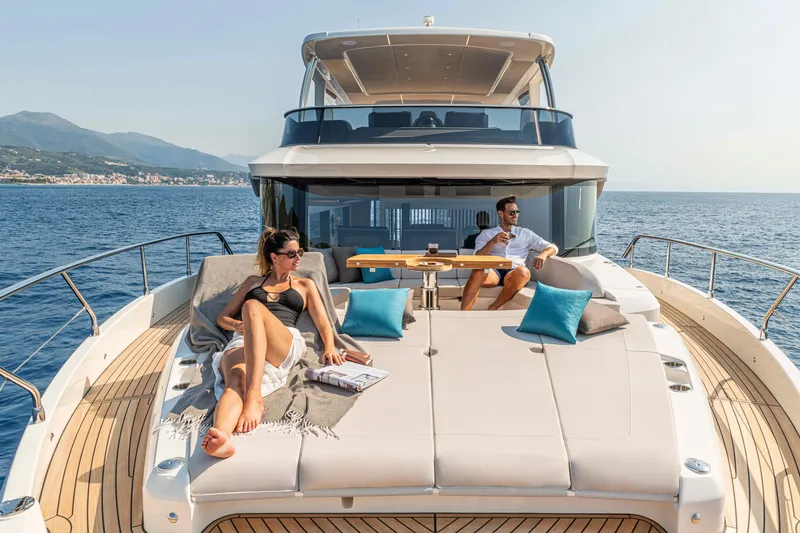 Slide: The Image of Couple relaxing on 2026 Absolute 70' Navetta yacht, enjoying sunny ocean views. - 11