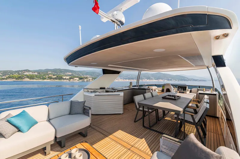 Slide: The Image of Luxurious 2026 Absolute 70' Navetta yacht deck with elegant seating and dining area. - 5