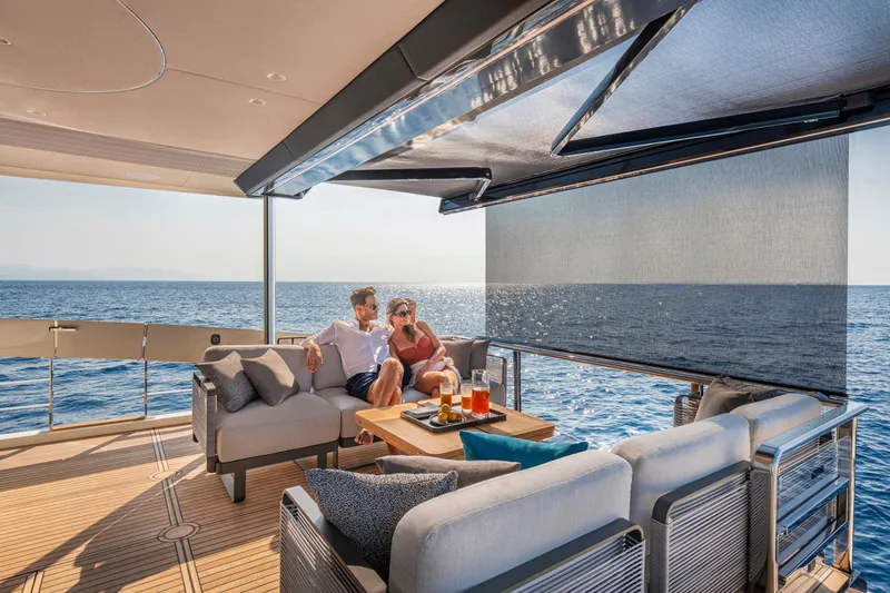 Slide: The Image of Couple relaxing on 2026 Absolute 70' Navetta yacht, enjoying ocean view. - 9