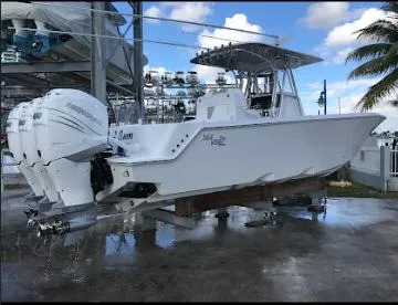Slide: The Image of 2020 SeaVee 340Z boat with dual outboard engines on a lift, under a blue sky. - 12