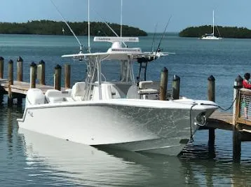 Slide: The Image of 2020 SeaVee 340Z boat docked in a serene marina setting. - 13