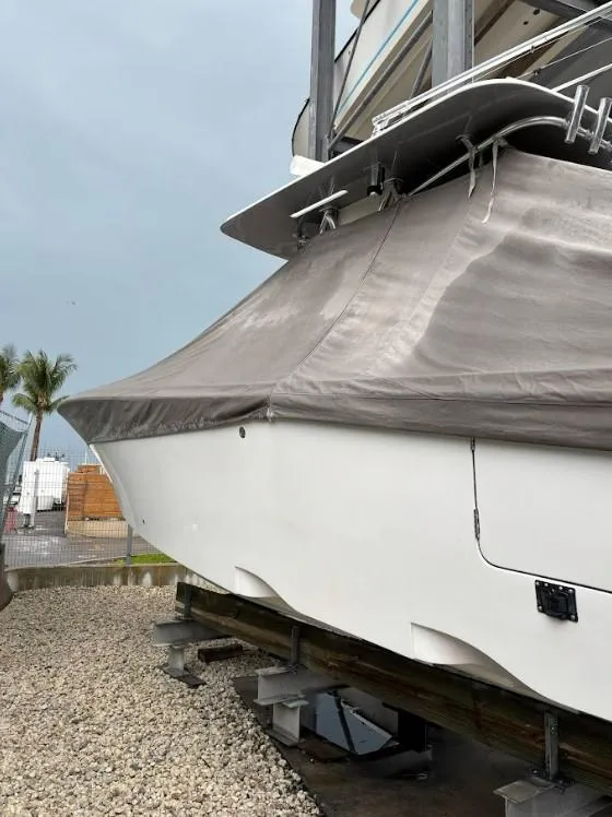 Slide: The Image of 2020 SeaVee 340Z boat covered and docked on gravel. - 16