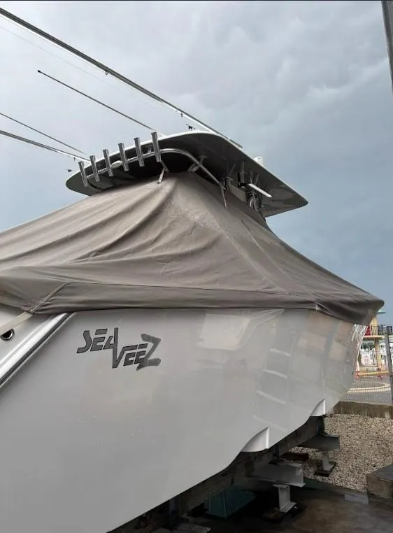 Slide: The Image of 2020 SeaVee 340Z boat covered, docked under cloudy sky. - 18