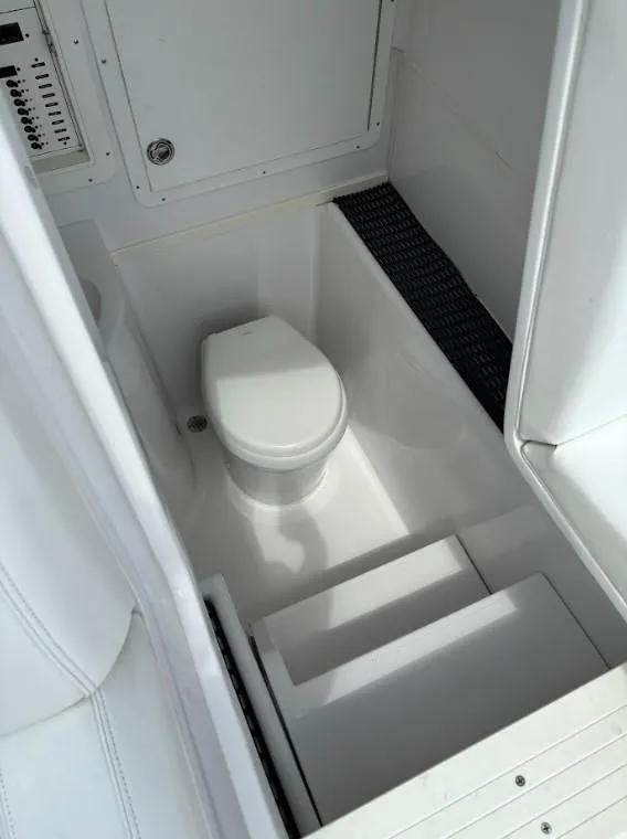 Slide: The Image of 2020 SeaVee 340Z boat interior with compact marine toilet. - 4