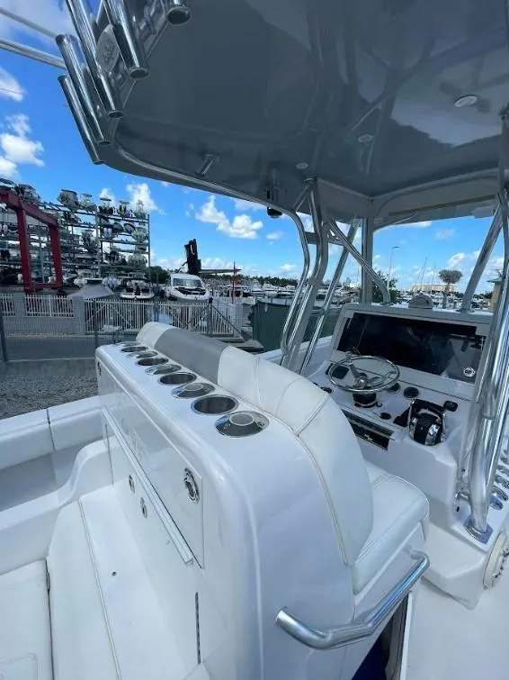 Slide: The Image of 2020 SeaVee 340Z boat cockpit with modern controls and seating, docked under a clear sky. - 9