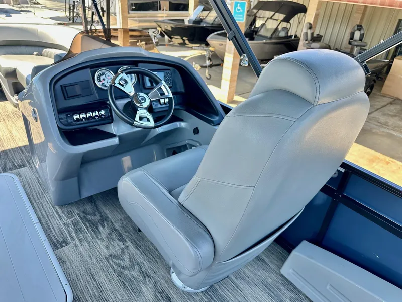 Slide: The Image of 2021 Avalon Catalina boat interior with steering wheel and captain's chair. - 21