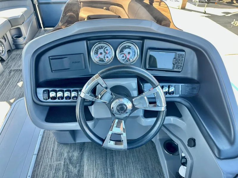 Slide: The Image of 2021 Avalon Catalina boat dashboard with steering wheel, gauges, and controls. - 22