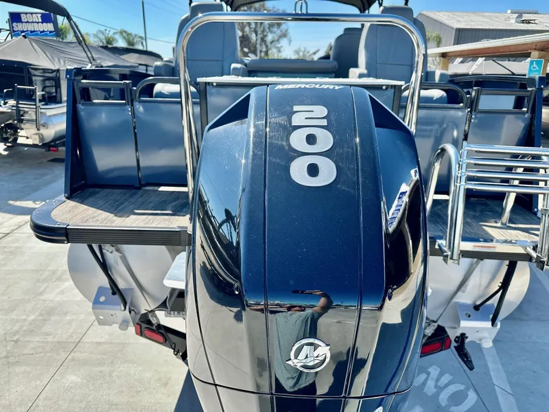 Slide: The Image of 2021 Avalon Catalina Rear Fish boat with 200HP Mercury engine, showcased outdoors. - 6