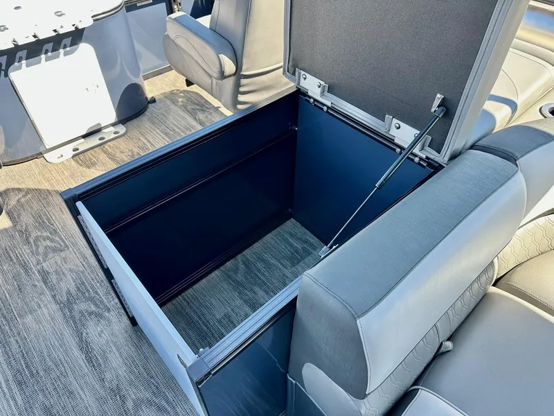 Slide: The Image of Open storage compartment in 2021 Avalon Catalina Rear Fish boat with gray seating. - 9
