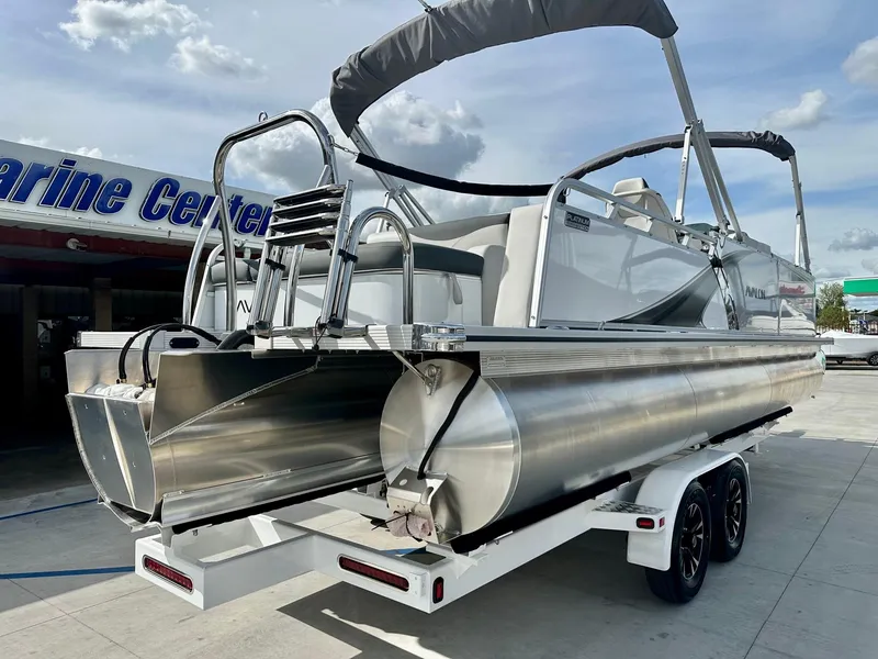 Slide: The Image of 2025 Avalon 25' LSZ Platinum pontoon boat with 225HP Mercury, on trailer at marine center. - 11