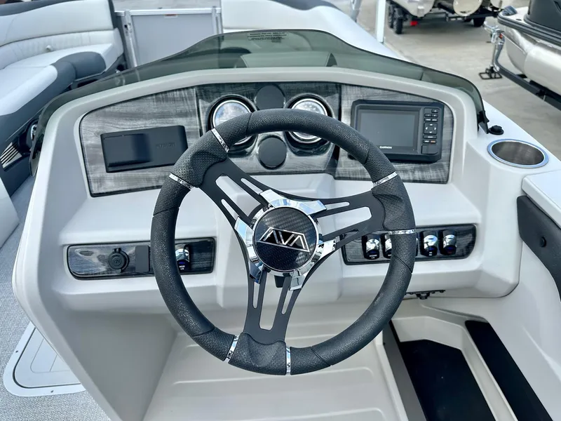 Slide: The Image of 2025 Avalon 25' LSZ Platinum boat dashboard with steering wheel and controls. - 7