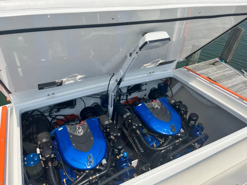 Slide: The Image of Engine compartment of a 2001 Cigarette Mystique boat with dual blue engines. - 3