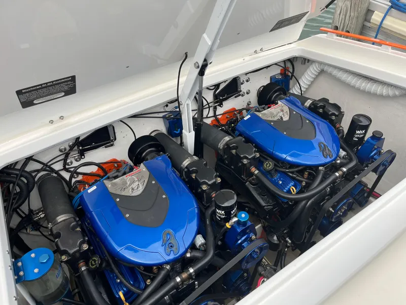 Slide: The Image of Twin blue engines in a 2001 Cigarette Mystique boat, showcasing detailed mechanics. - 5