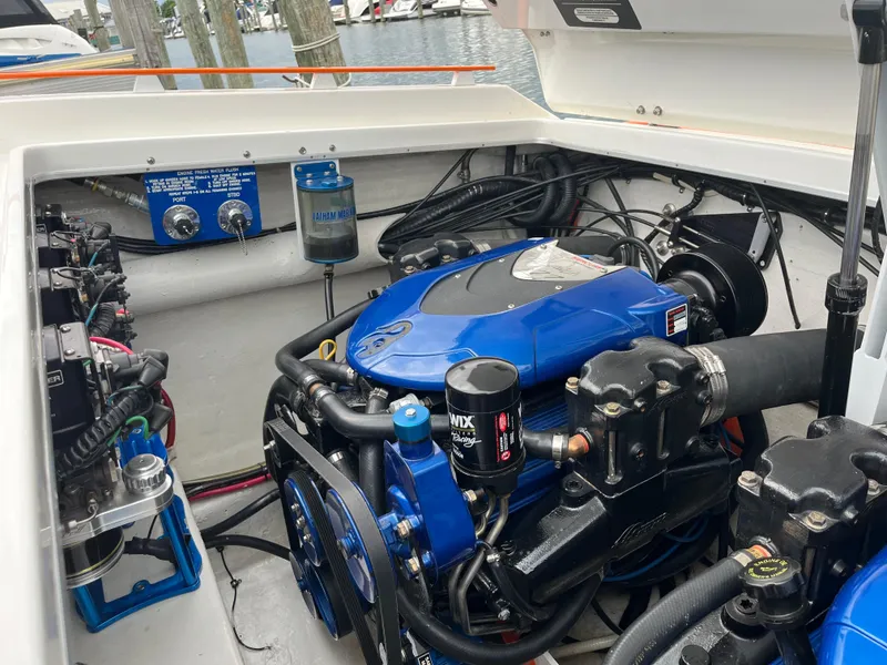 Slide: The Image of Engine compartment of a 2001 Cigarette Mystique boat, featuring a blue engine. - 6