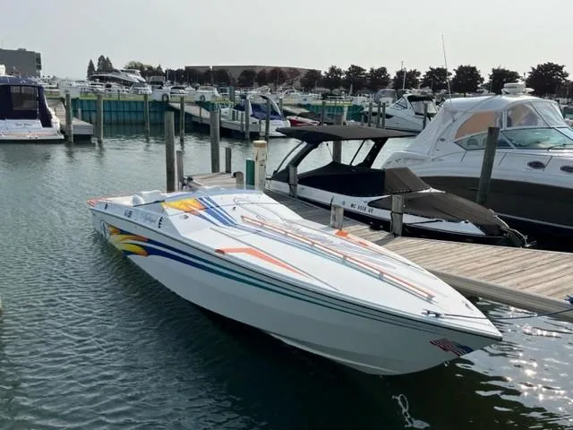Slide: The Image of 2001 Cigarette Mystique speedboat docked in a marina, featuring colorful graphics. - 7