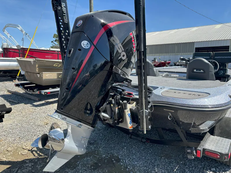 Slide: The Image of 2023 Falcon F20 PREDATOR boat with powerful outboard motor, parked on gravel. - 15