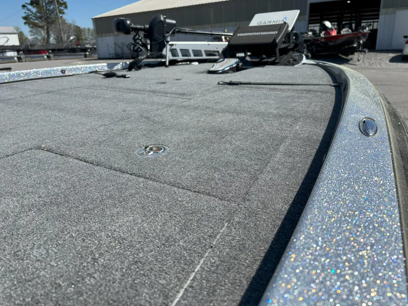 Slide: The Image of 2023 Falcon F20 PREDATOR boat deck with fishing equipment and sparkly trim. - 2