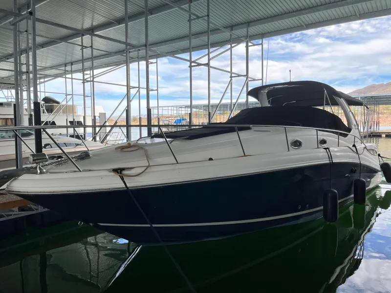 Slide: The Image of 2006 Sea Ray 340 Sundancer docked in a covered marina. - 1