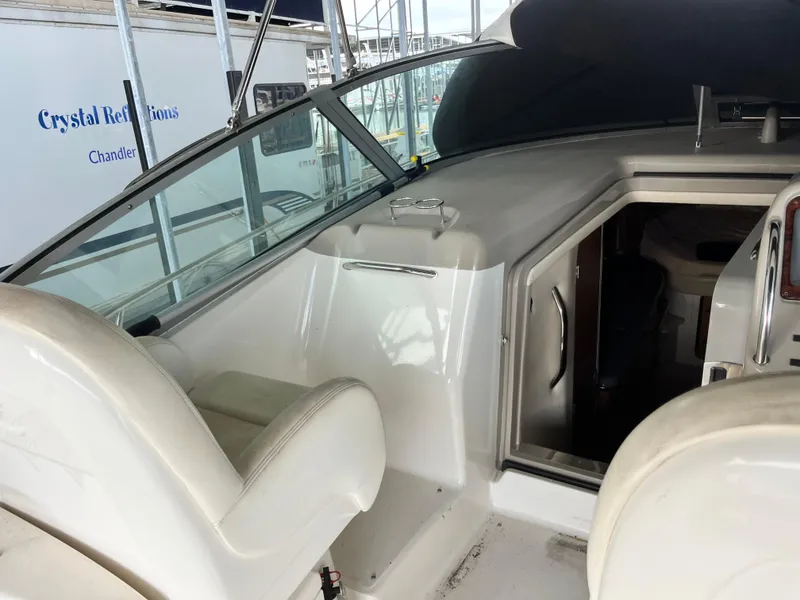 Slide: The Image of 2006 Sea Ray 340 Sundancer cockpit with seating and cabin entrance. - 13